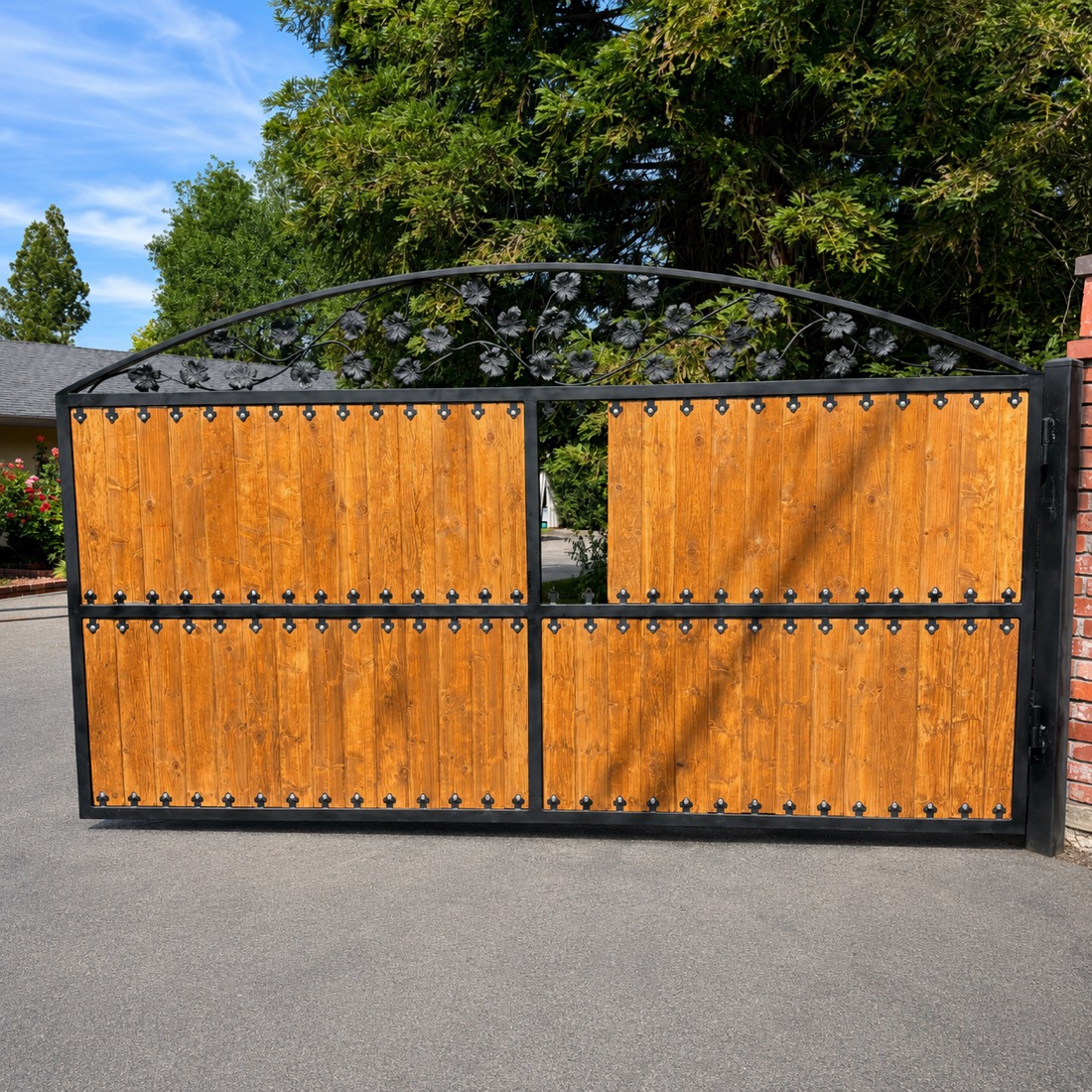 Ornate wrought iron and wood gate with forged scrollwork