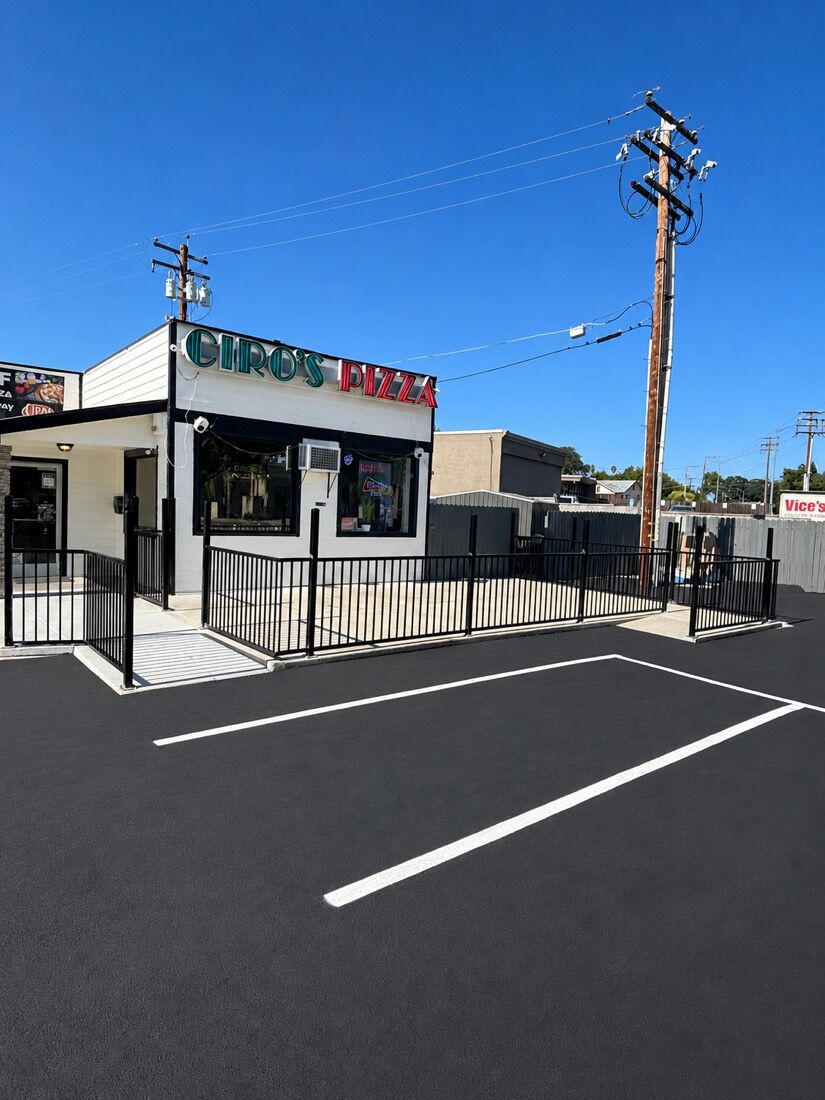 Black steel patio railing enclosing a commercial restaurant patio
